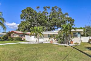 a house with palm trees in front of it at Clearwater Retreat Near Beach, Golf, and Boating! in Clearwater