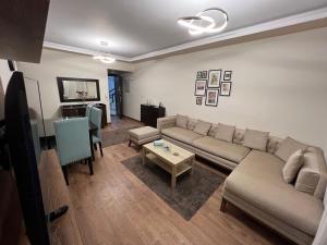 a living room with a couch and a table at Families Only - Rehab 2 - Two Bedrooms Flat for you in Burg el-Ḥudûd