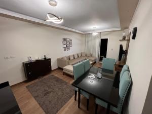 a living room with a dining table and a couch at Families Only - Rehab 2 - Two Bedrooms Flat for you in Burg el-Ḥudûd