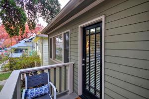 a porch with a blue bench and a door at Charming 2Bed French Colonial Apartment in Desirable Midtown Sacramento in Sacramento