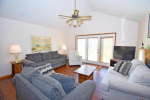 a living room with couches and a flat screen tv at Fountain Road Home in Ocean City +4 photos