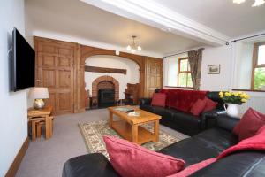 a living room with a couch and a fireplace at Tywysog in Henllan
