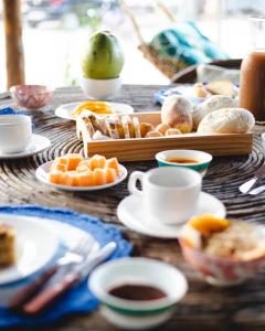 a table with plates of food and cups of coffee at Abis Beach Suites in Prea