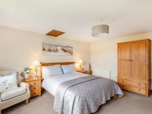 a bedroom with a bed and a chair at The Nook in Louth