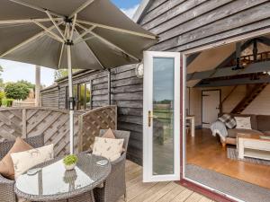 a patio with a table and an umbrella at The Nook in Louth