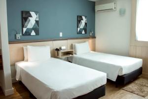 เตียงในห้องที่ Comfort Hotel Campos dos Goytacazes