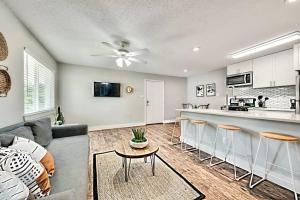 a living room with a couch and a kitchen at Lovely Dallas Flat Near Downtown in Dallas