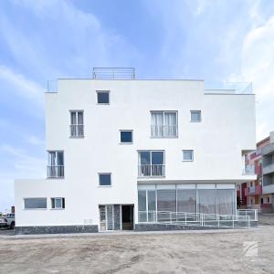 a white building with windows and a sky at Ka Djula in Sal Rei