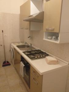 a kitchen with a sink and a stove top oven at Salento da amare in Marina di Mancaversa +7 photos