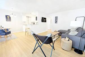 a living room with a couch and a table and chairs at The City Escape & Arboretum Tickets Included in Dallas