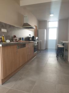 a kitchen with wooden cabinets and a counter top at SCI EMEL in Le Creusot