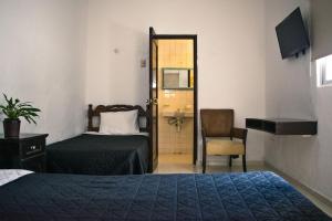 Postel nebo postele na pokoji v ubytování Hotel Cupules