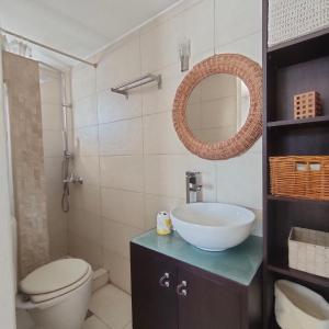 a bathroom with a sink and a toilet and a mirror at MUSEUM apartment in Volos