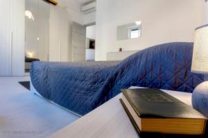 a book sitting on a table next to a bed at La reggia del mar - Genova Sturla, mare e Gaslini in Genova