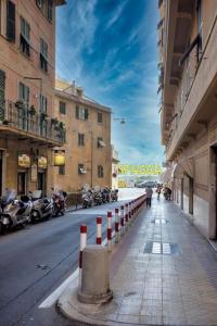 a person walking down a street in a city at La reggia del mar - Genova Sturla, mare e Gaslini in Genova