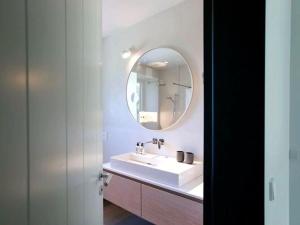 a bathroom with a sink and a mirror at Exklusives Landhaus auf Fehmarn in Schlagsdorf +29 photos