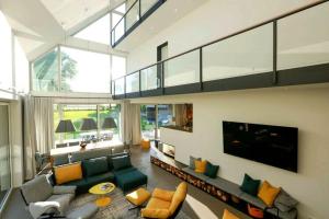 a large living room with a couch and a tv at Exklusives Landhaus auf Fehmarn in Schlagsdorf