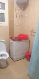 a bathroom with a toilet and a red sink at The Vew in Sharm El Sheikh