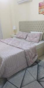 a bedroom with a large bed with pink sheets and pillows at The Vew in Sharm El Sheikh