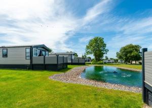 a holiday home with a swimming pool in a yard at Green Meadows Country Park in Harker