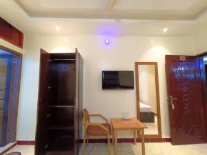 a room with a table and a chair and a door at Sea Front Resort in Cox's Bazar