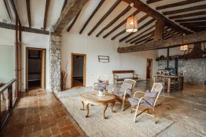 a large living room with a table and chairs at Casa Rural El Callís in Vall de Bianya