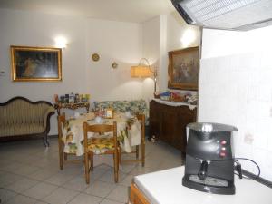 a kitchen with a table and chairs in a room at B&B Home Sweet Home in Diano Marina