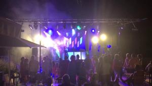 a crowd of people watching a band on a stage at night at Camping Moulin de Paulhiac in Daglan +34 photos
