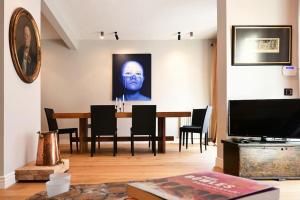 a living room with a dining room table with a painting at Architect's Art House right on Taksim Square in Istanbul