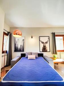 a bedroom with a large blue bed in a room at Disfruta De La Naturaleza - Vistas al Rio - Luz Natural - 6pax in Canillo