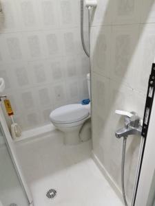 a small bathroom with a toilet and a shower at Vacations in Patra Rooms in Patra