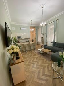 a living room with a couch and a kitchen at PJ apartment in Budapest