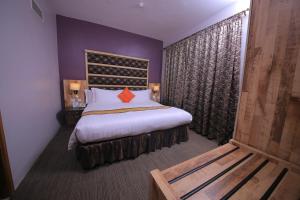 A bed or beds in a room at Arcadia Suites - Kampala