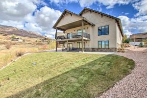 a house on a hill with a large yard at Scenic Eden Gem with Hot Tub about 6 Mi to Ski Area in Eden