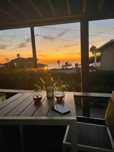 a picnic table with a view of the sunset at Contemporary Ocean Sunset Views with Firepit Pt Loma close to PLNU in San Diego