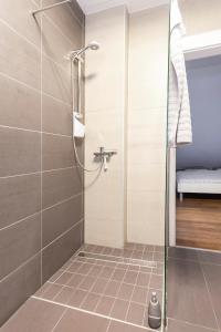 a shower with a glass door in a bathroom at Hillhouse Novo mesto in Novo Mesto +24 photos