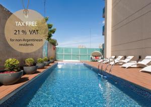 a swimming pool with lounge chairs next to a building at Palladio Hotel Buenos Aires - MGallery in Buenos Aires