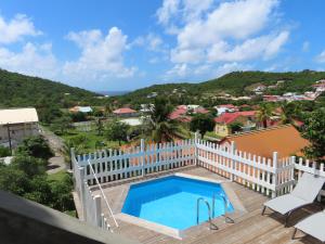 a view from the balcony of a house with a swimming pool at TERRE DE BAS :L'île merveilleuse in Terre-de-Bas