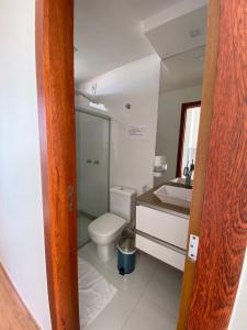 a bathroom with a toilet and a sink at Pousada Ritec in Linhares