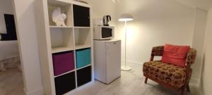 a room with a refrigerator and a chair and a tv at pardelo in Adeje