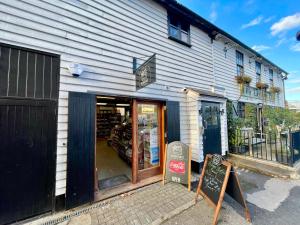 a store with its door open on a street at Fantastic 2 Bed Perfect for Stansted Airport in Bishops Stortford