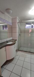 a bathroom with a shower and a sink and a mirror at Yacht Coast in Fortaleza