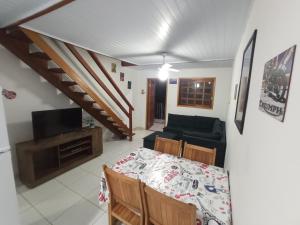a living room with a table and a couch at Maranduba Ville II in Ubatuba