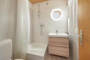 a white bathroom with a sink and a toilet at Cosy studio for 5 near ski lift, HAMEAU D2 in Les Collons