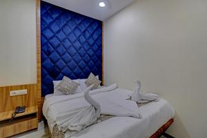 Airoli的住宿－Ivory Suites，一间卧室配有一张蓝色床头板的床