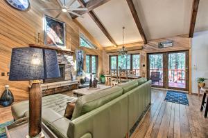 a living room with a couch and a tv at Cozy Angel Fire Escape with Golf Course Views! in Angel Fire