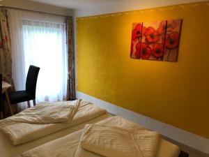 a bedroom with two beds and a painting on the wall at Schloßnerhof in Virgen