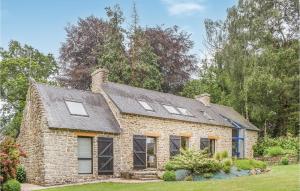 a brick house with windows and a roof at 3 Bedroom Stunning Home In Pont Aven in Pont-Aven