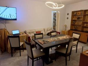 a living room with a table and chairs and a tv at Belgrano in Buenos Aires