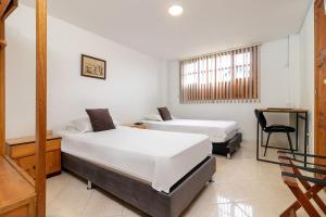 Postel nebo postele na pokoji v ubytování Hotel Gran Boutique Sabana